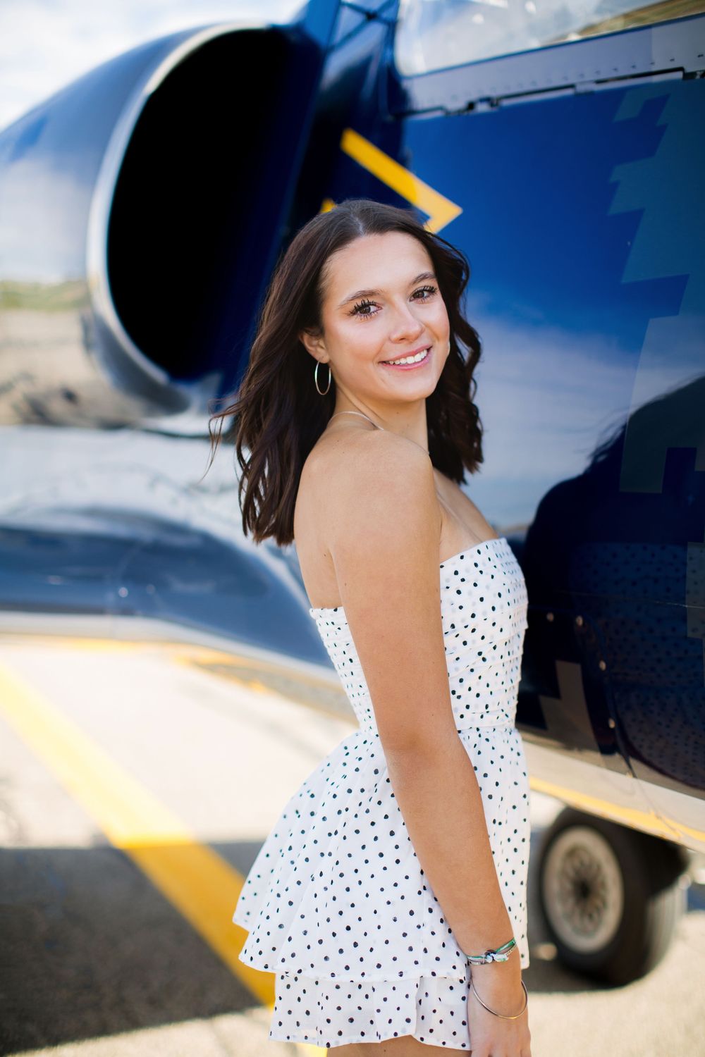 Modern high school senior portrait with jet plane in Howell Michigan; senior aviation photos by Brighton, MI photographer