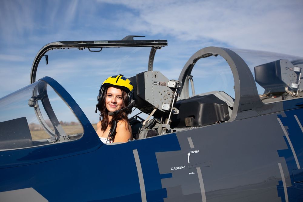 High school senior portrait with pilot girl in jet plane in Howell Michigan; senior aviation photos by Brighton, MI photographer