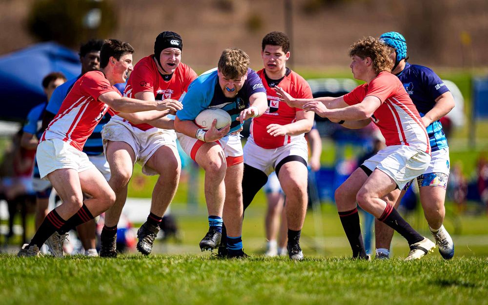 Elizabethtown Blues Rugby player drives through CV defenders at Old Trolley Line Park, March 2026 — SportsFox Photography