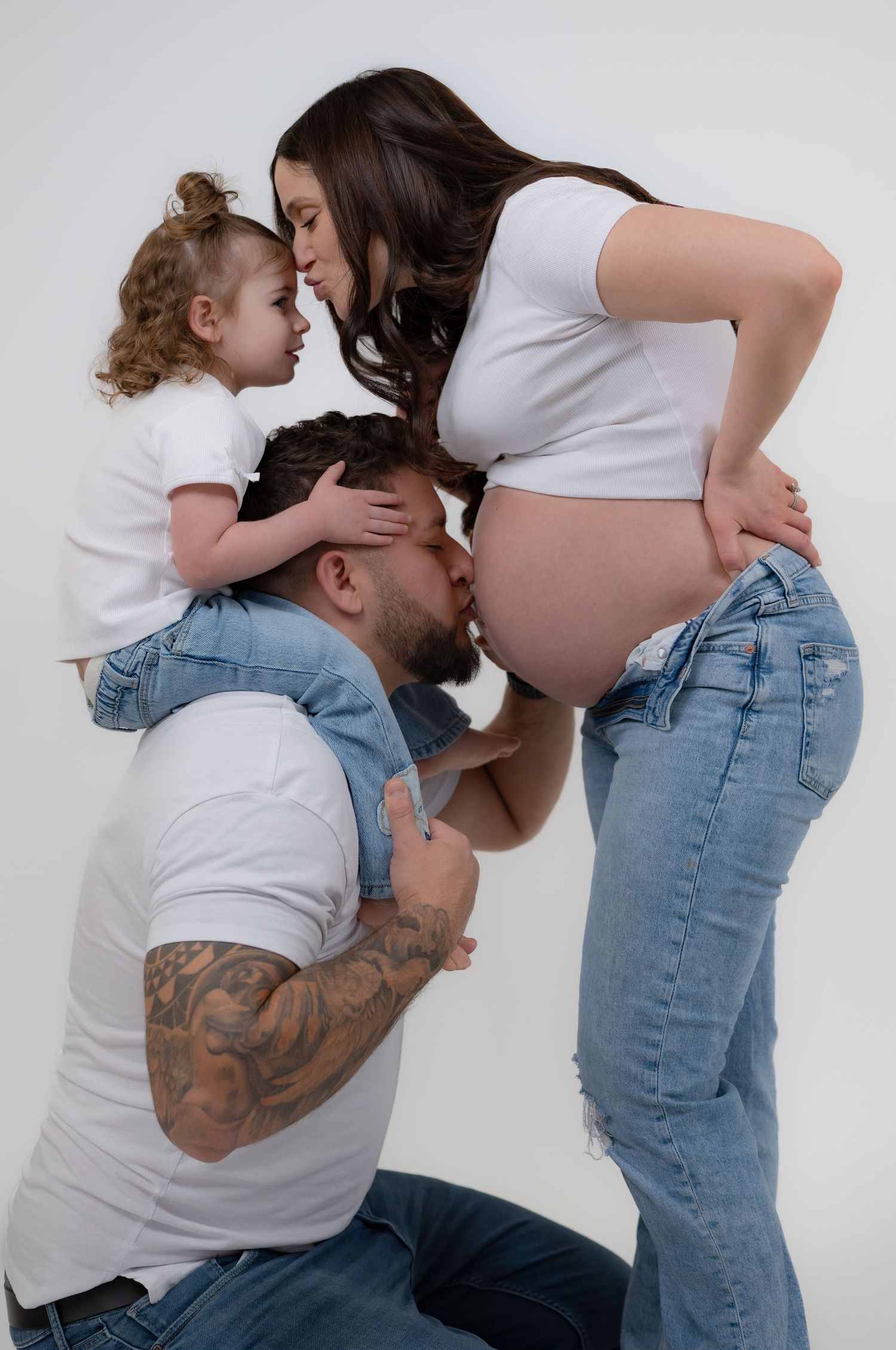 mother, husband and daughter posing for family session photography at gorilla studio