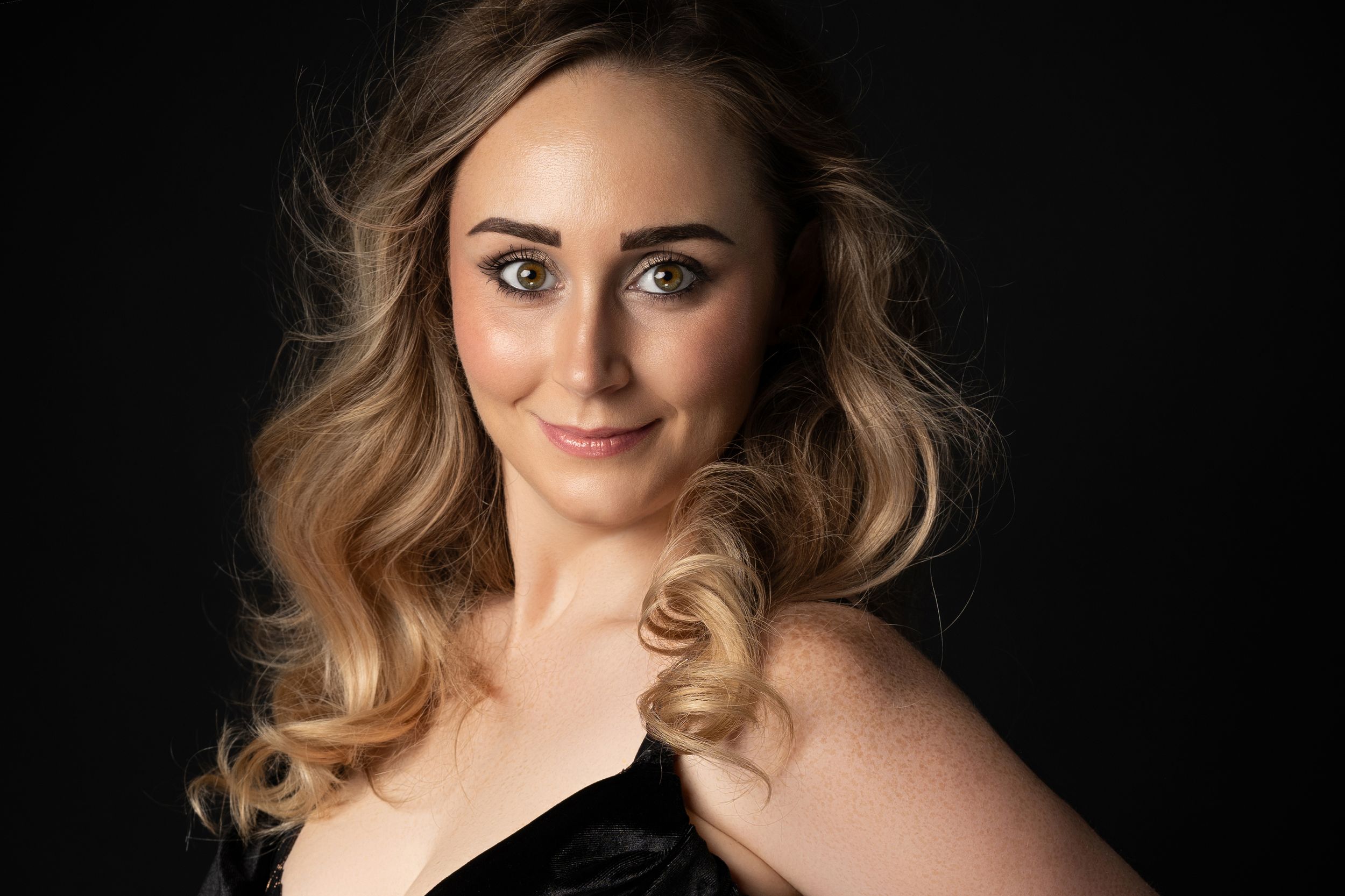 Close-up portrait of a woman with elegant styling, photographed in a professional studio near Glasgow.