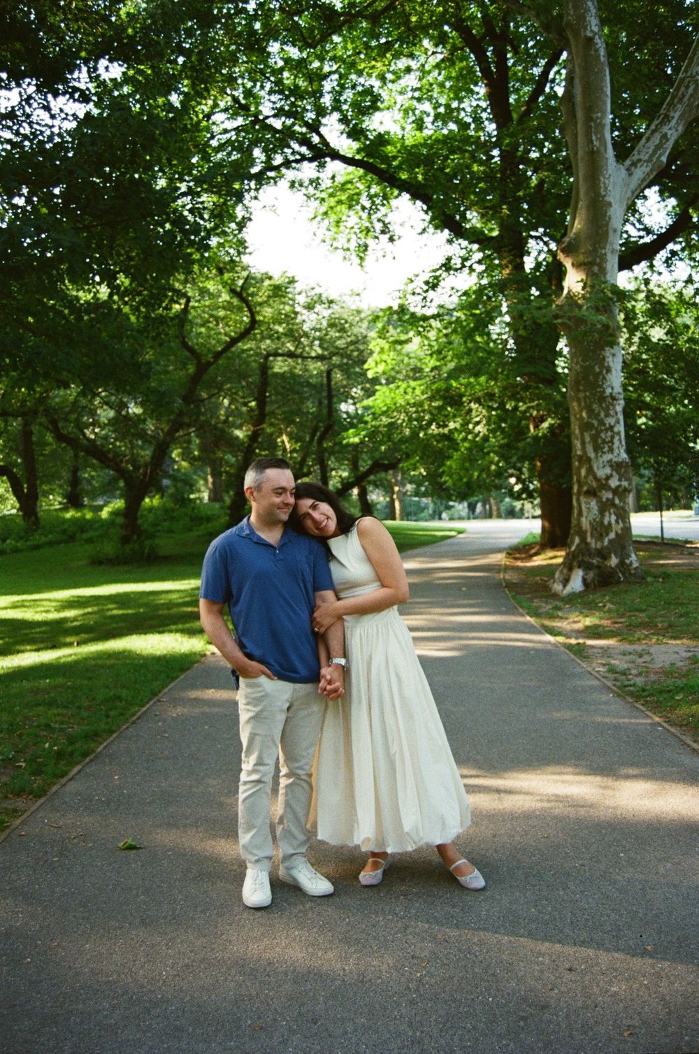 NYC engagement photographer capturing candid couple portraits in Central Park with natural light and film photography