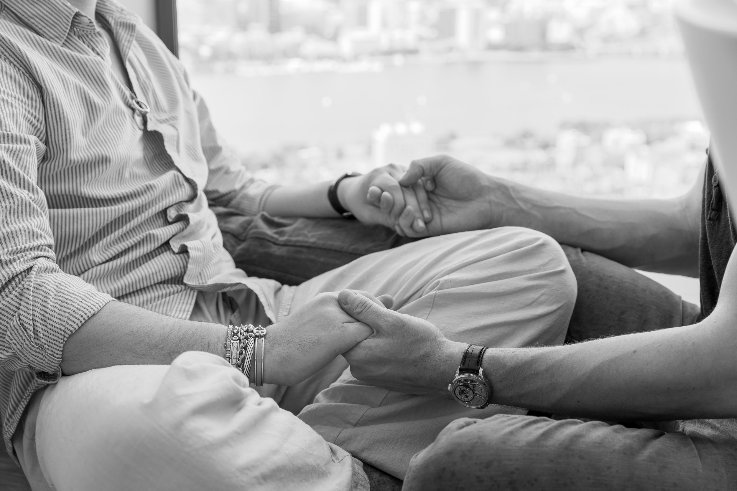 Wedding guests relaxing in casual attire during outdoor celebration.