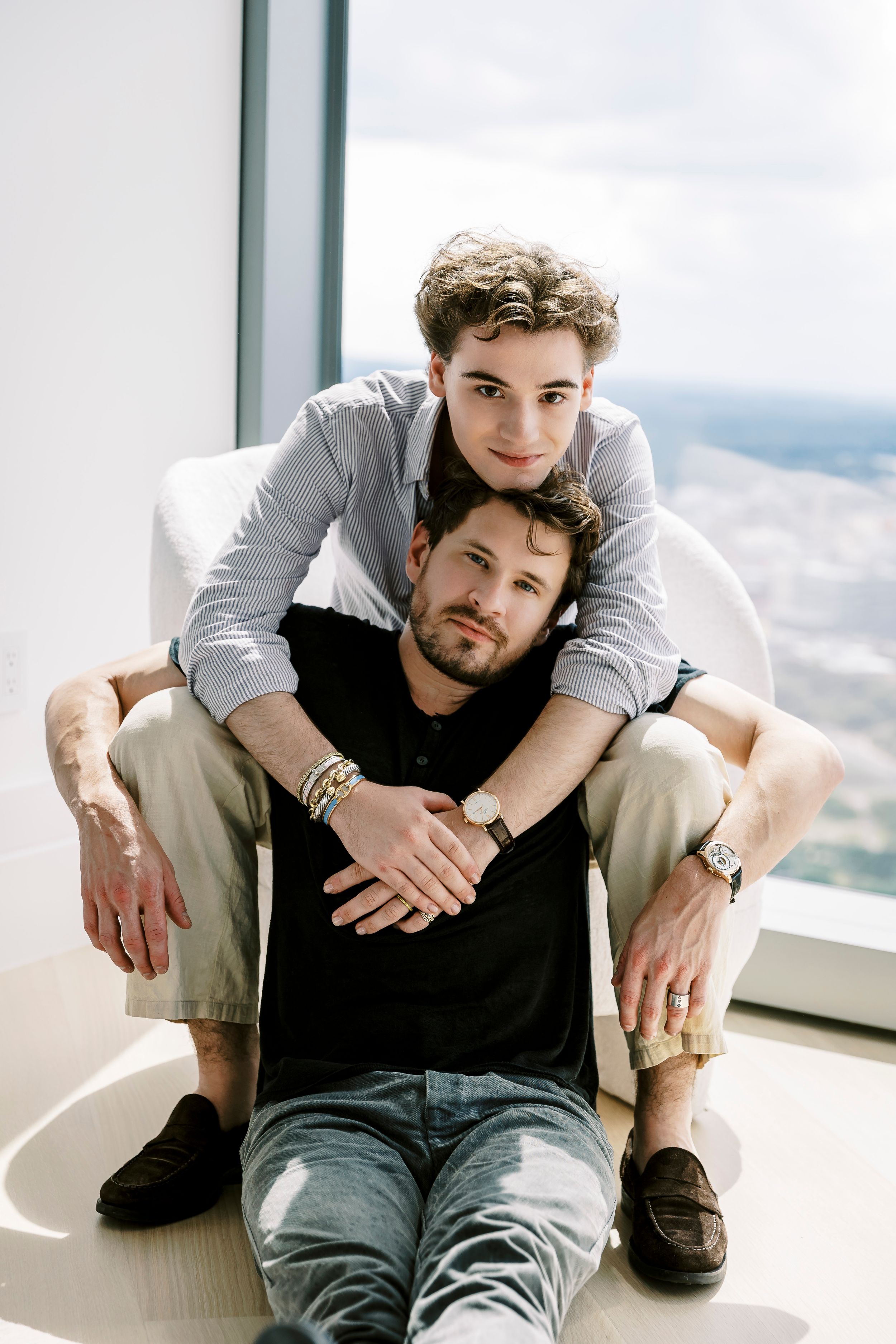 Natural light photography capturing intimate moments in contemporary apartment setting.