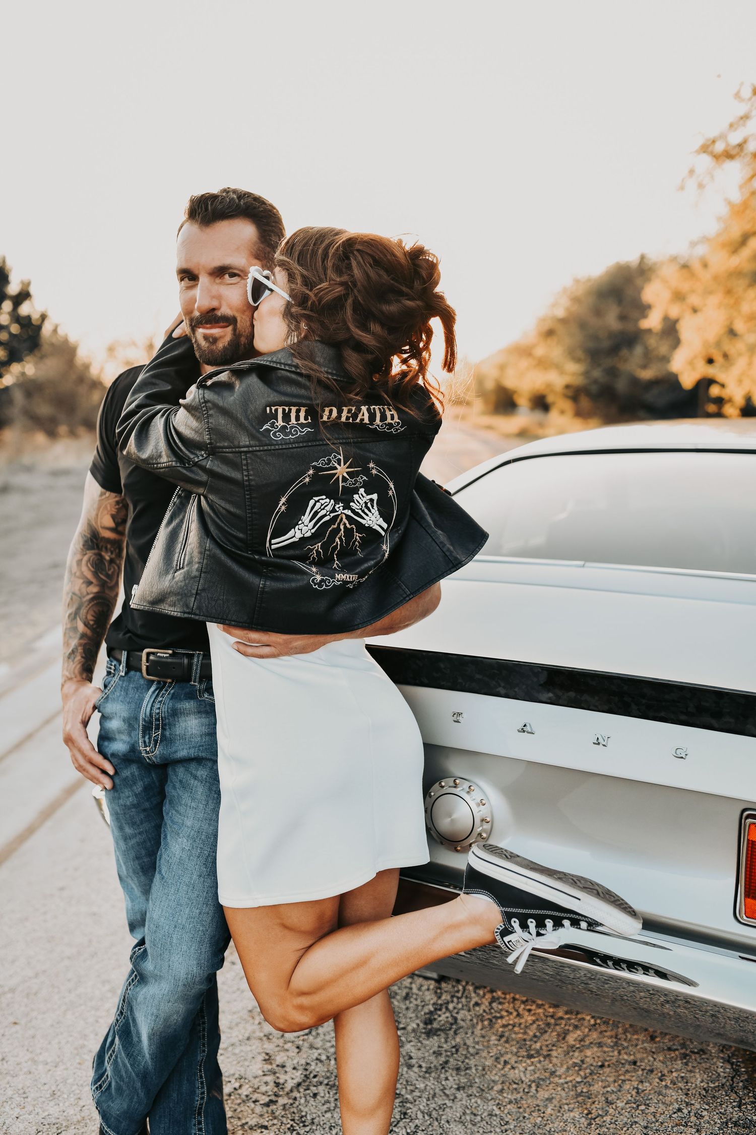 romantic couple sitting on vintage Mustang hood editorial engagement session