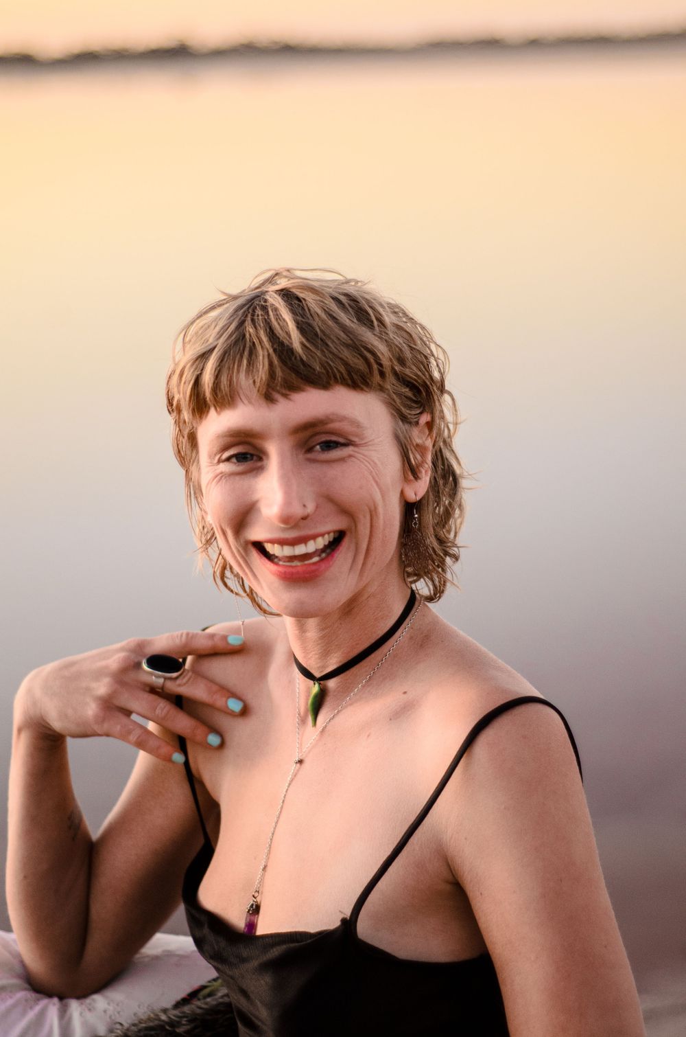 Sunset portrait with delicate necklace and natural evening lighting.