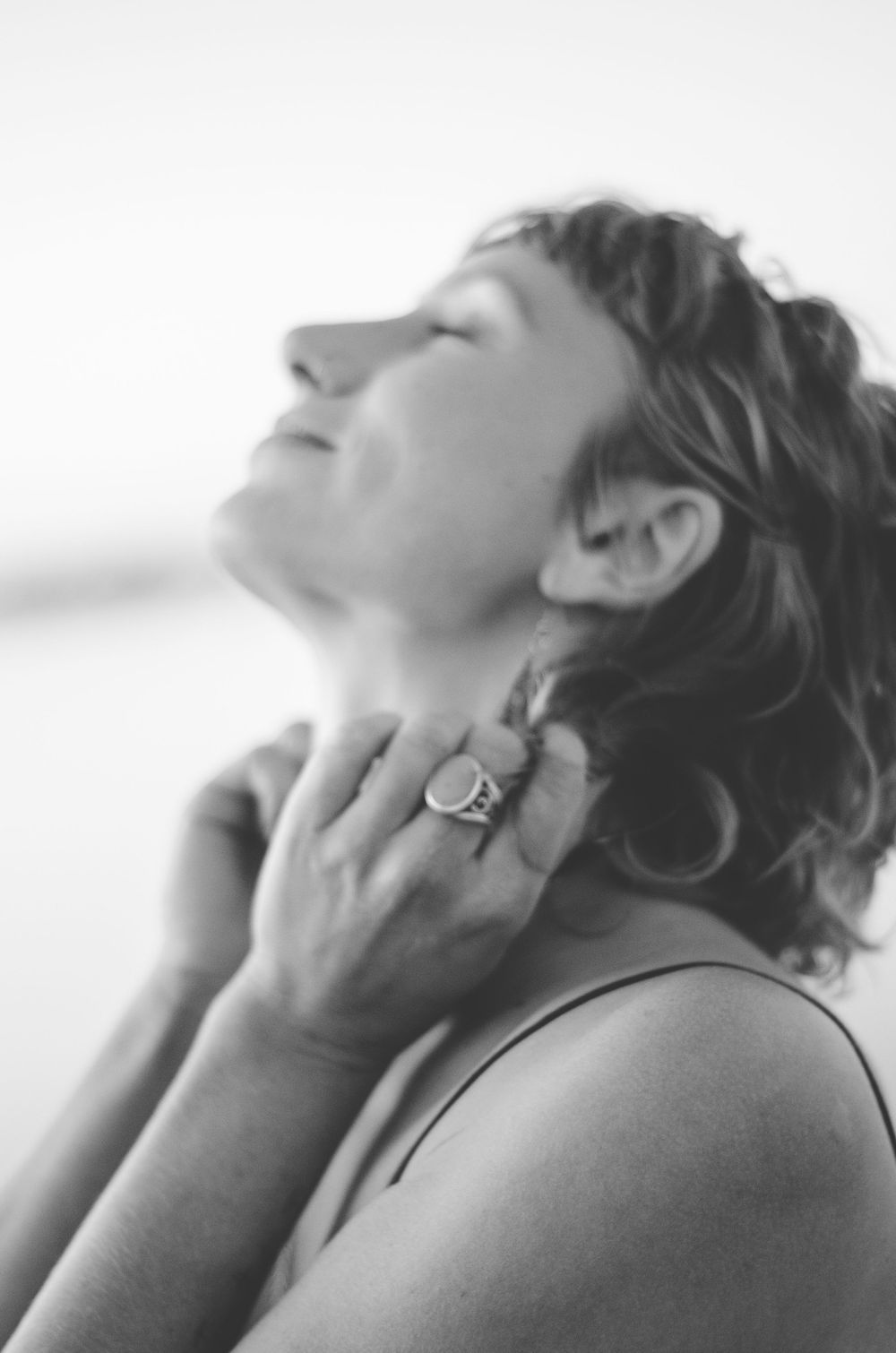Artistic black and white profile shot showing emotional expression.