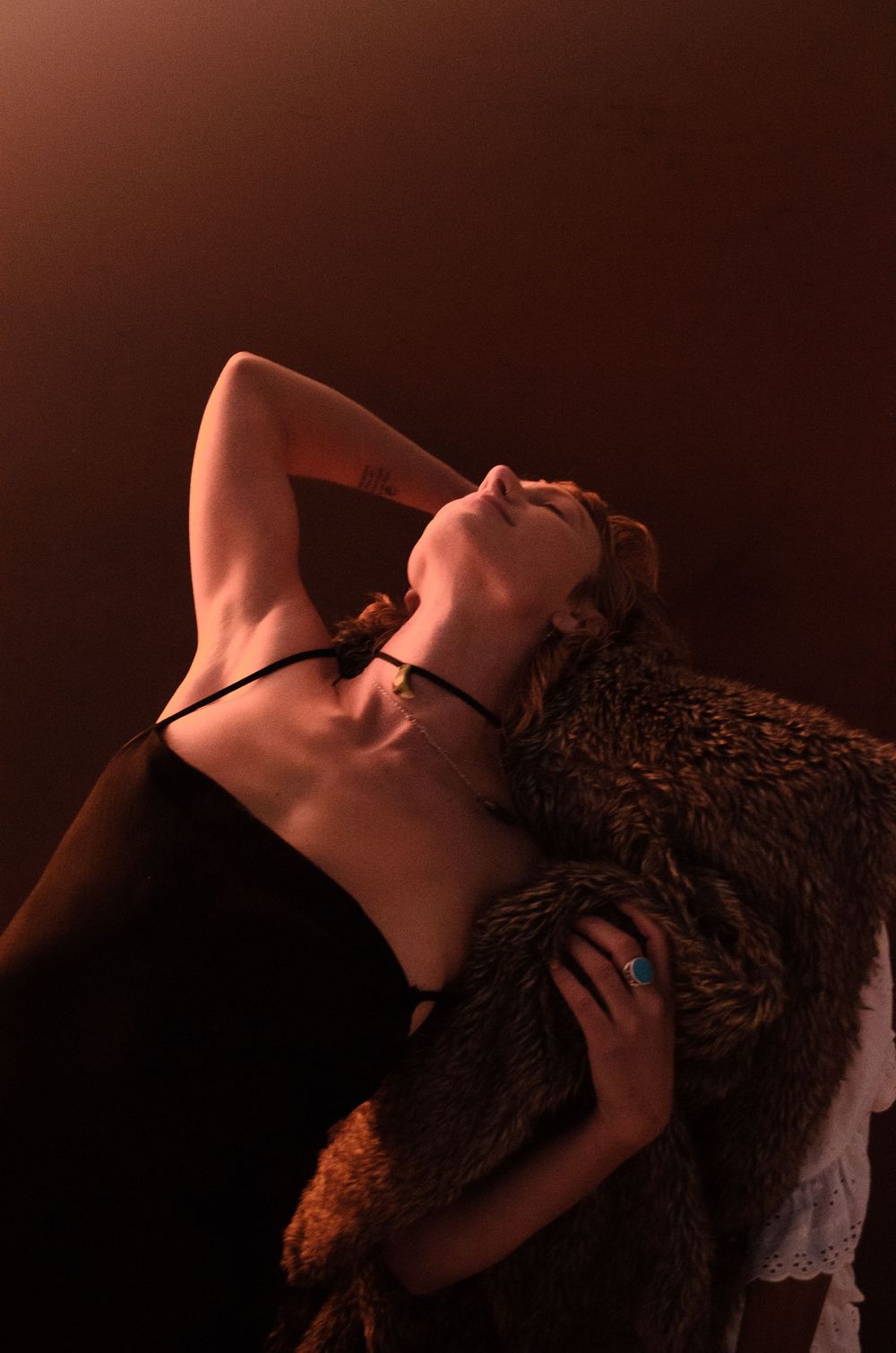 Intimate dance portrait with dramatic lighting and rich amber tones.