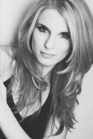 Black and white glamour portrait with styled blonde hair and dramatic makeup.