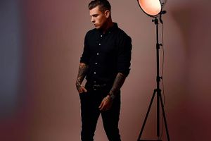 Studio fashion portrait with dramatic lighting and professional lighting equipment.