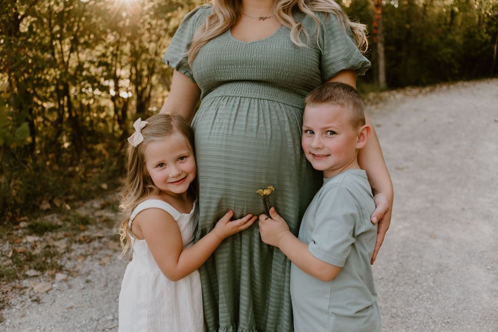 Natural light family photography session with coordinated sage green outfits.