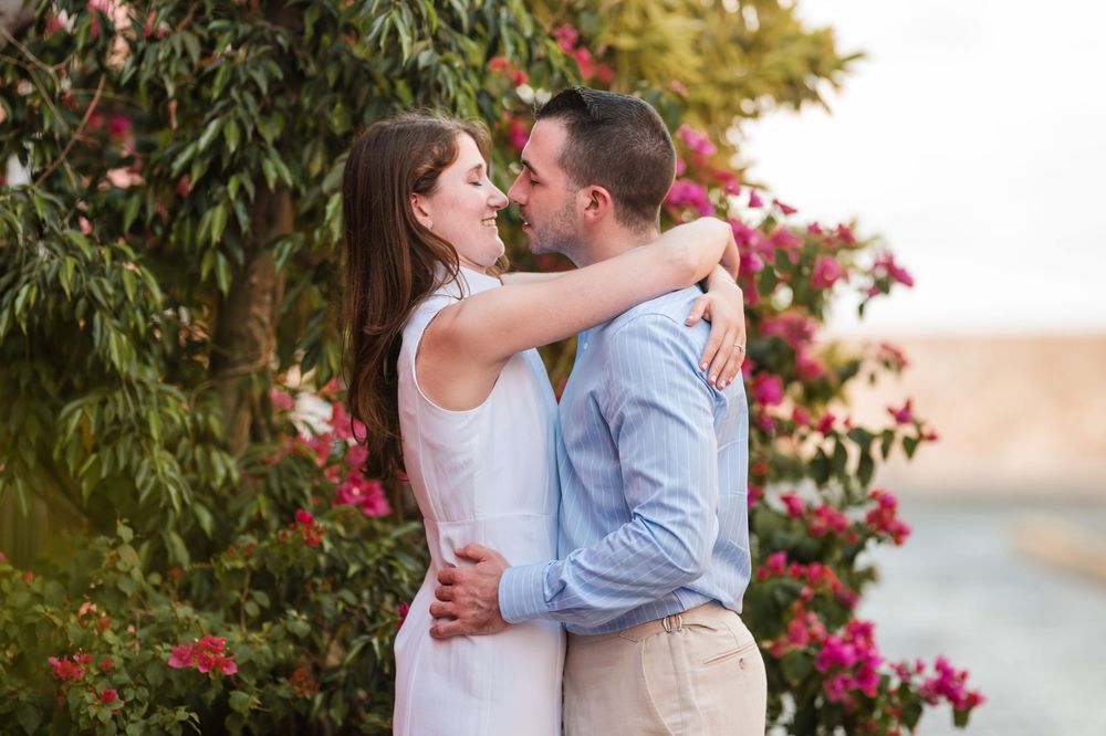 Close up of couple kissing surrounded by flowers in Old San Juan Puerto Rico