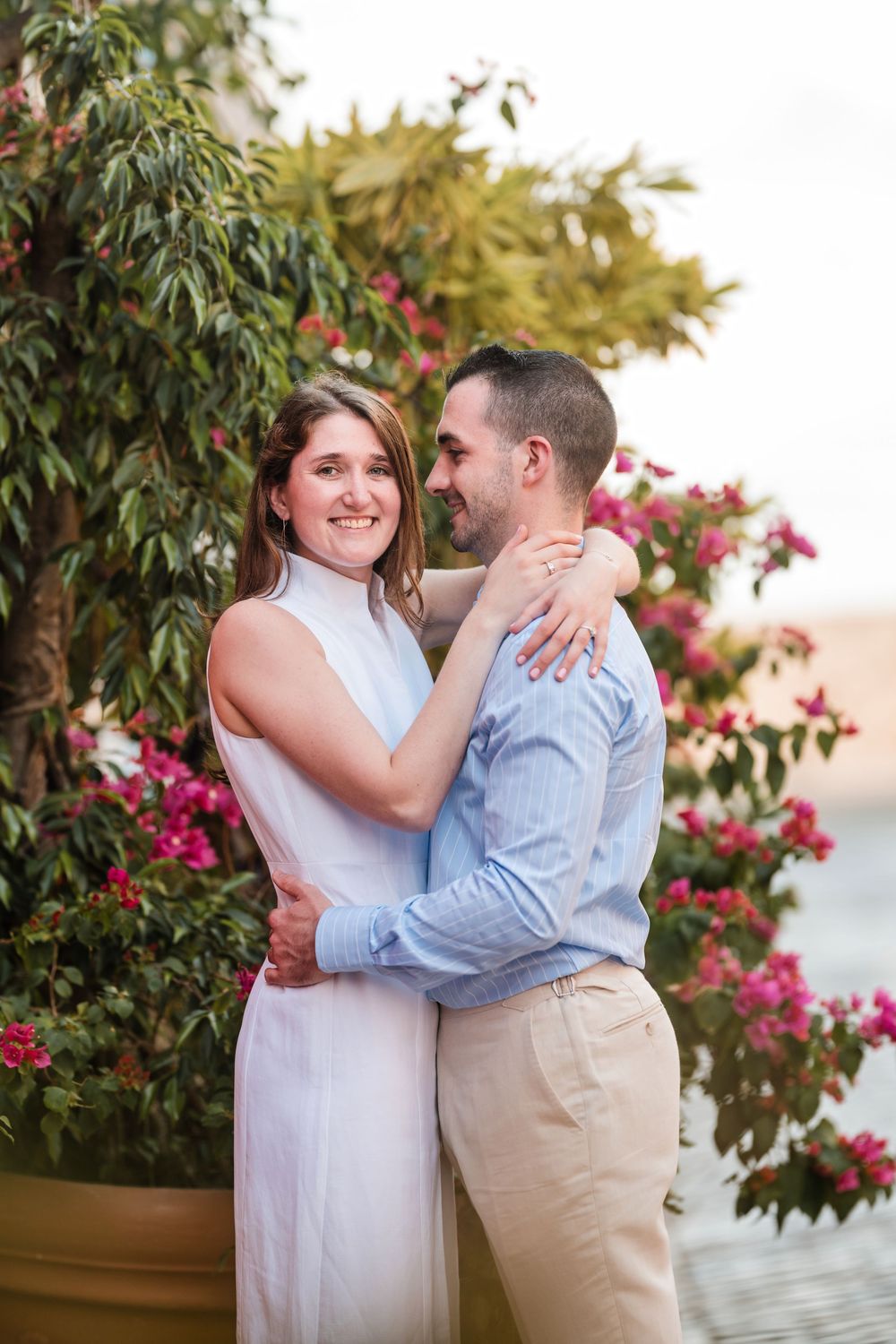 Couple embracing near tropical flowers in Old San Juan Puerto Rico engagement session