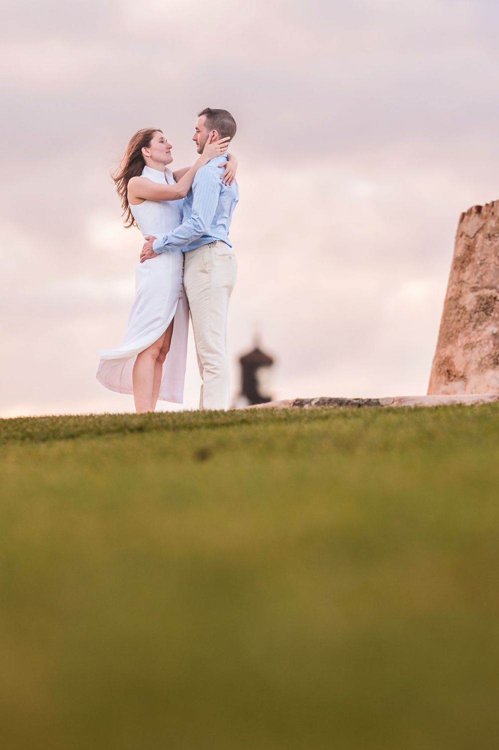 Couple standing together on open field with pastel sky in Old San Juan Puerto Rico