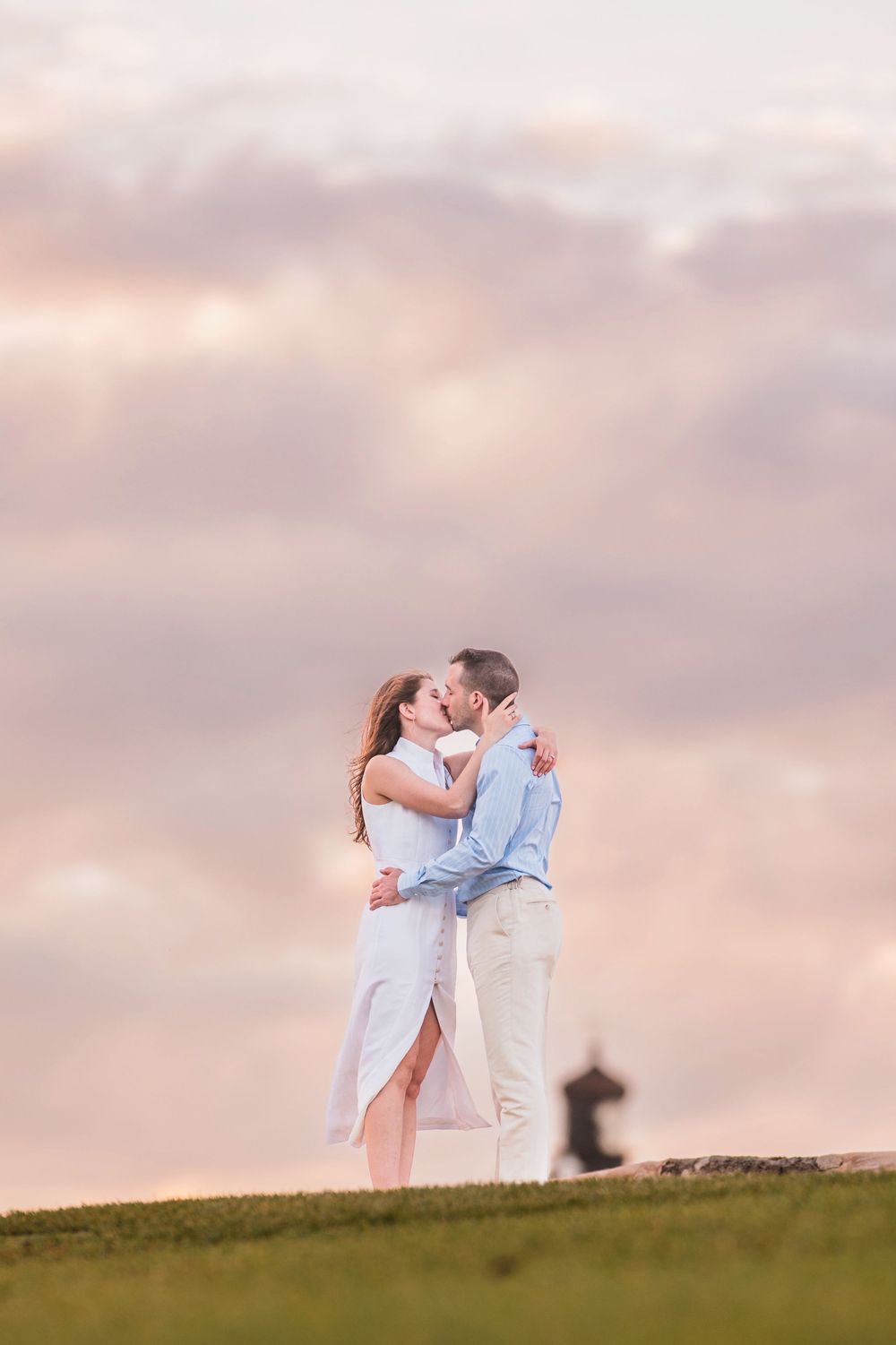 Couple embracing on hill during sunset engagement session in San Juan Puerto Rico