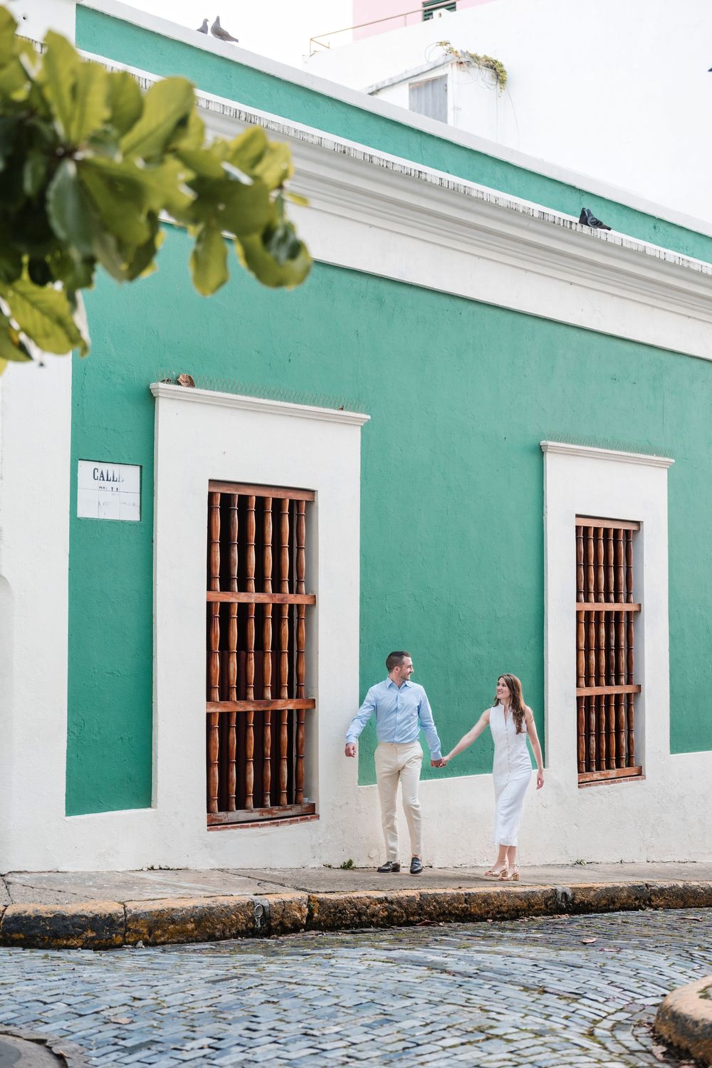Colorful street scene in Old San Juan Puerto Rico with couple walking together