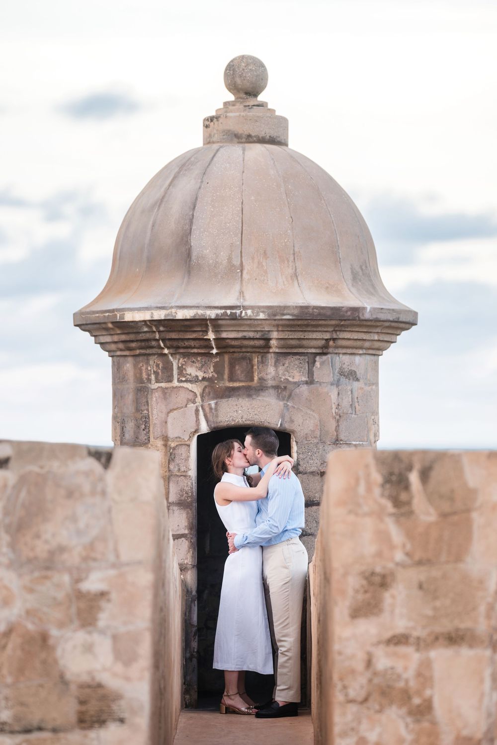 Couple framed by historic garita with ocean views in Old San Juan Puerto Rico