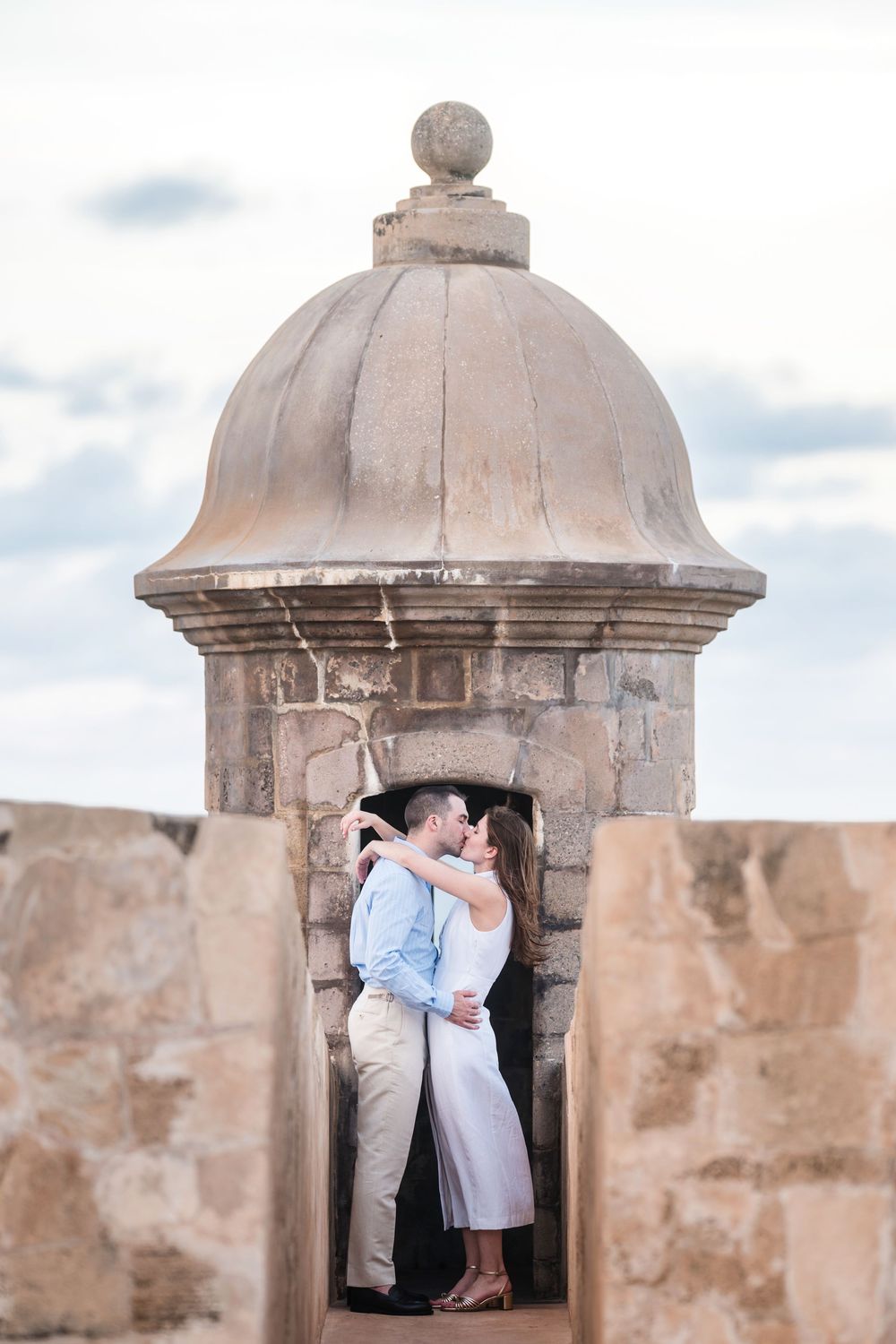 Couple standing inside stone lookout tower in Old San Juan Puerto Rico