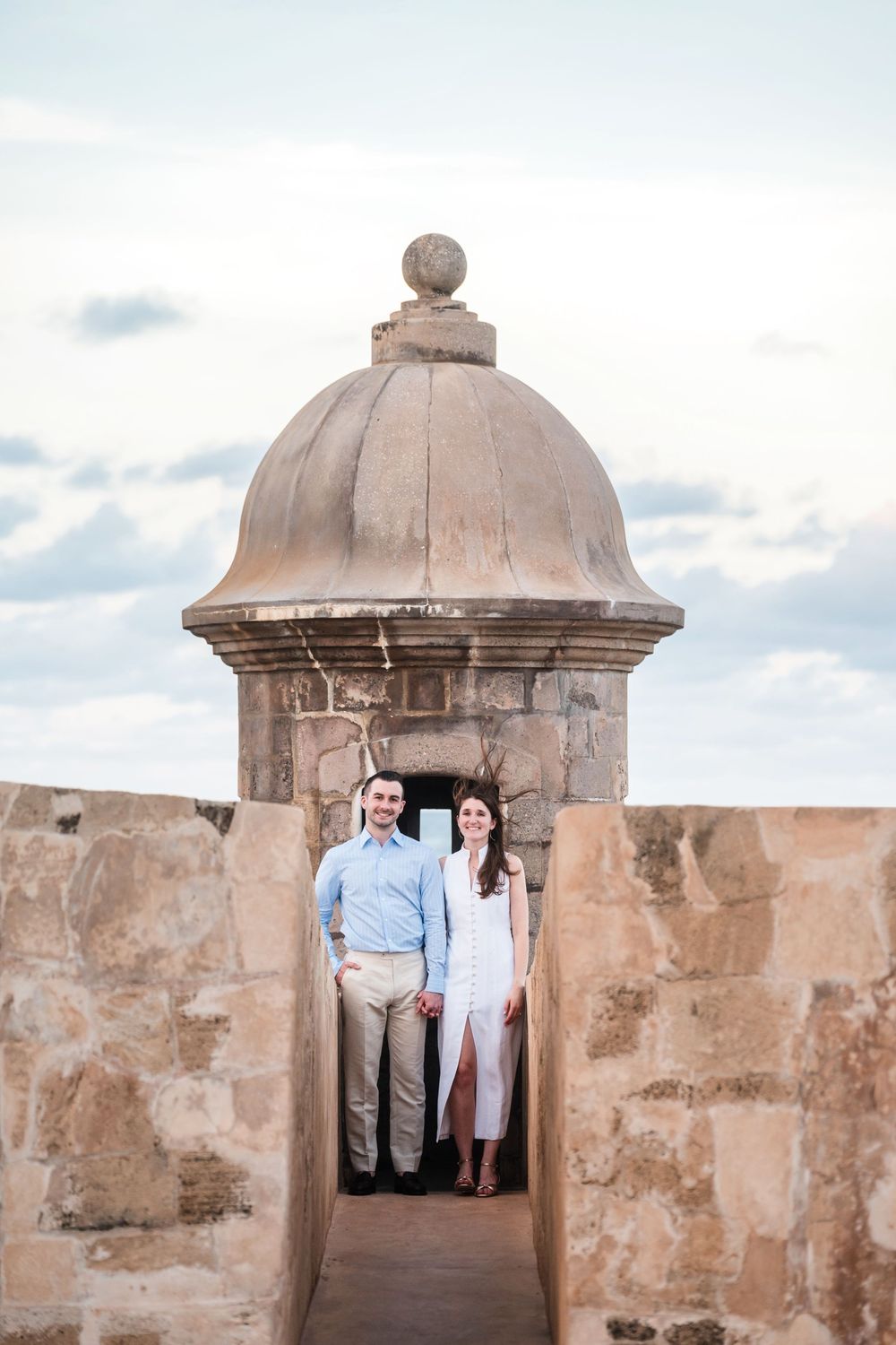 Couple standing inside stone lookout tower in Old San Juan Puerto Rico