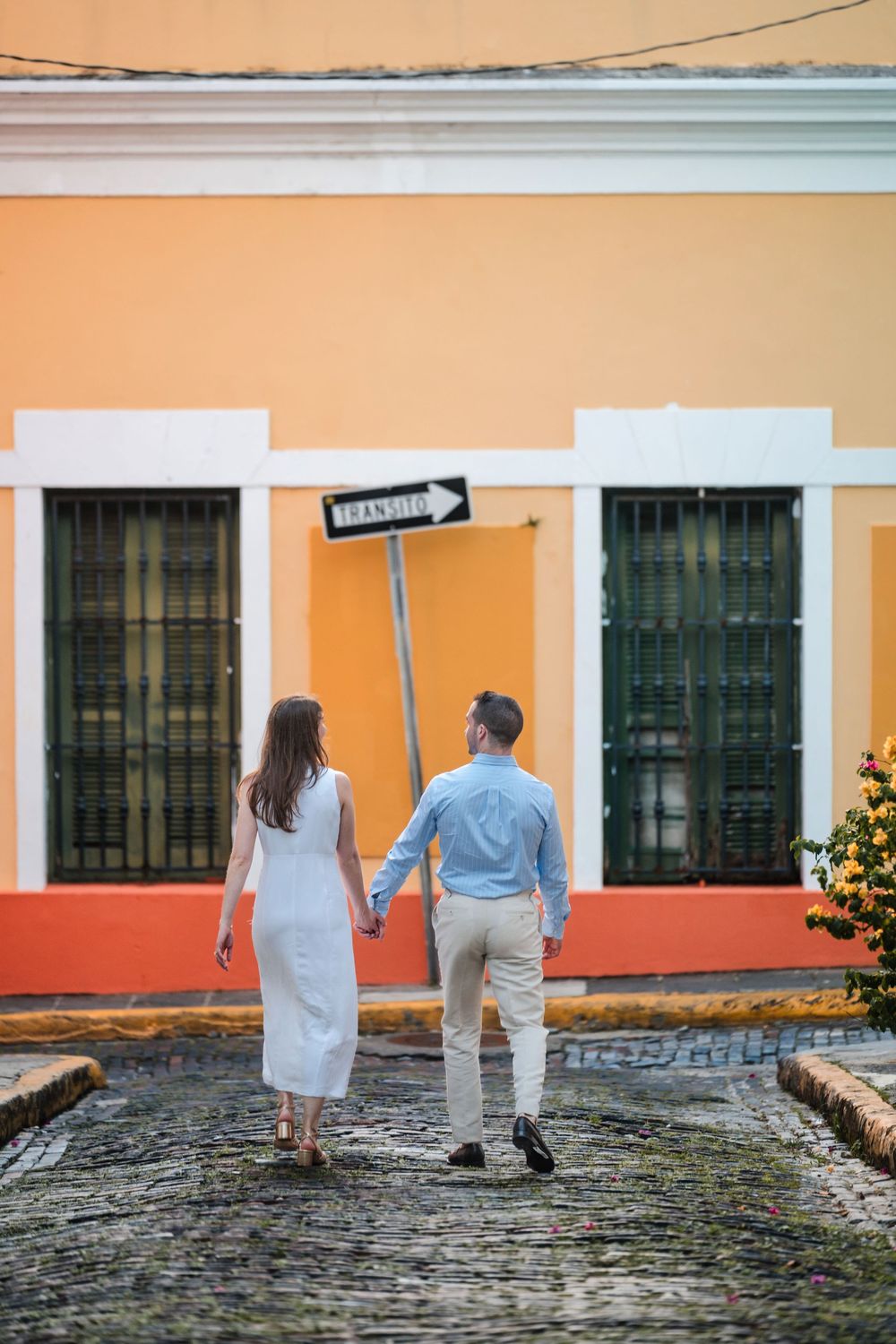 Couple standing in front of vibrant colonial buildings in Old San Juan Puerto Rico