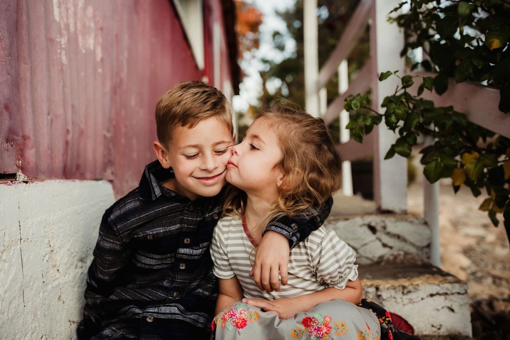 Sweet family portrait series showing affectionate moments and embraces outdoors during autumn.