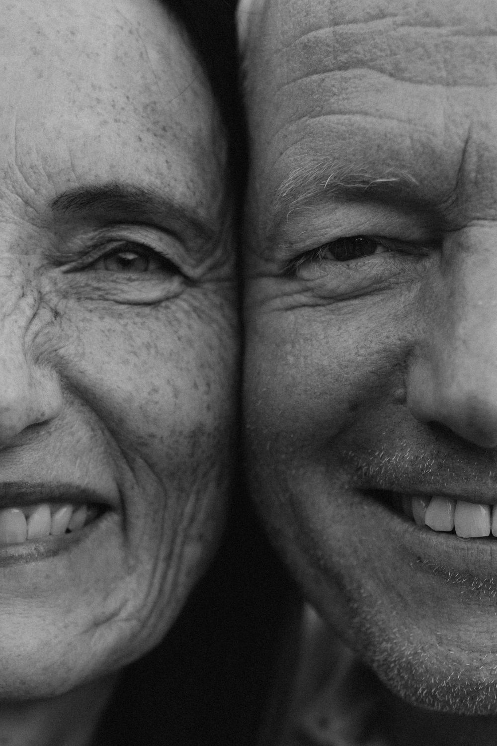 Close-up black and white portrait series showing joyful expressions and genuine smiles.