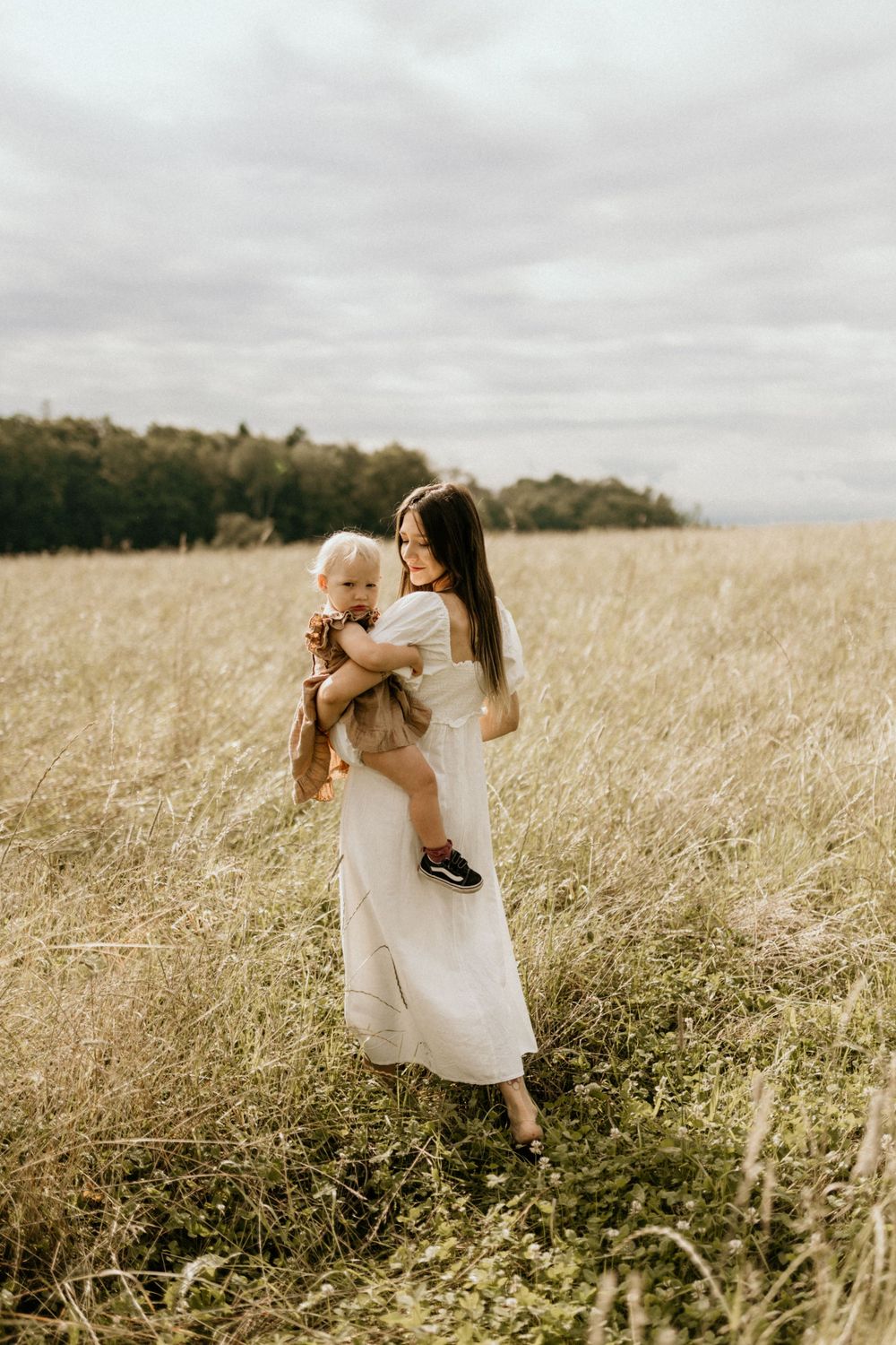 A series of candid moments captured in a golden wheat field on an overcast day.