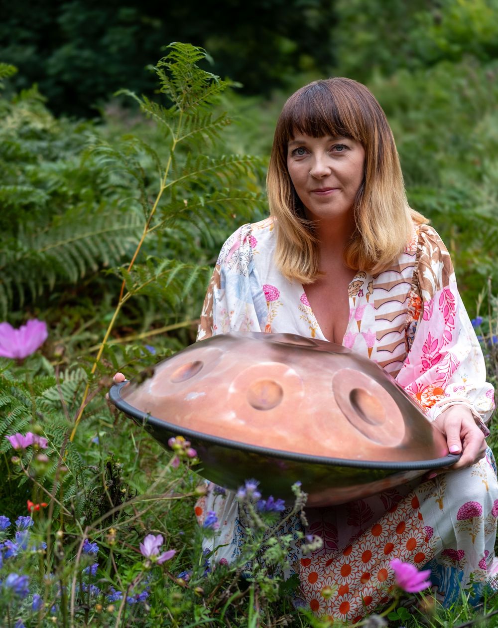 A series of garden images showing someone holding a large decorative copper birdbath among ferns and pink flowers.