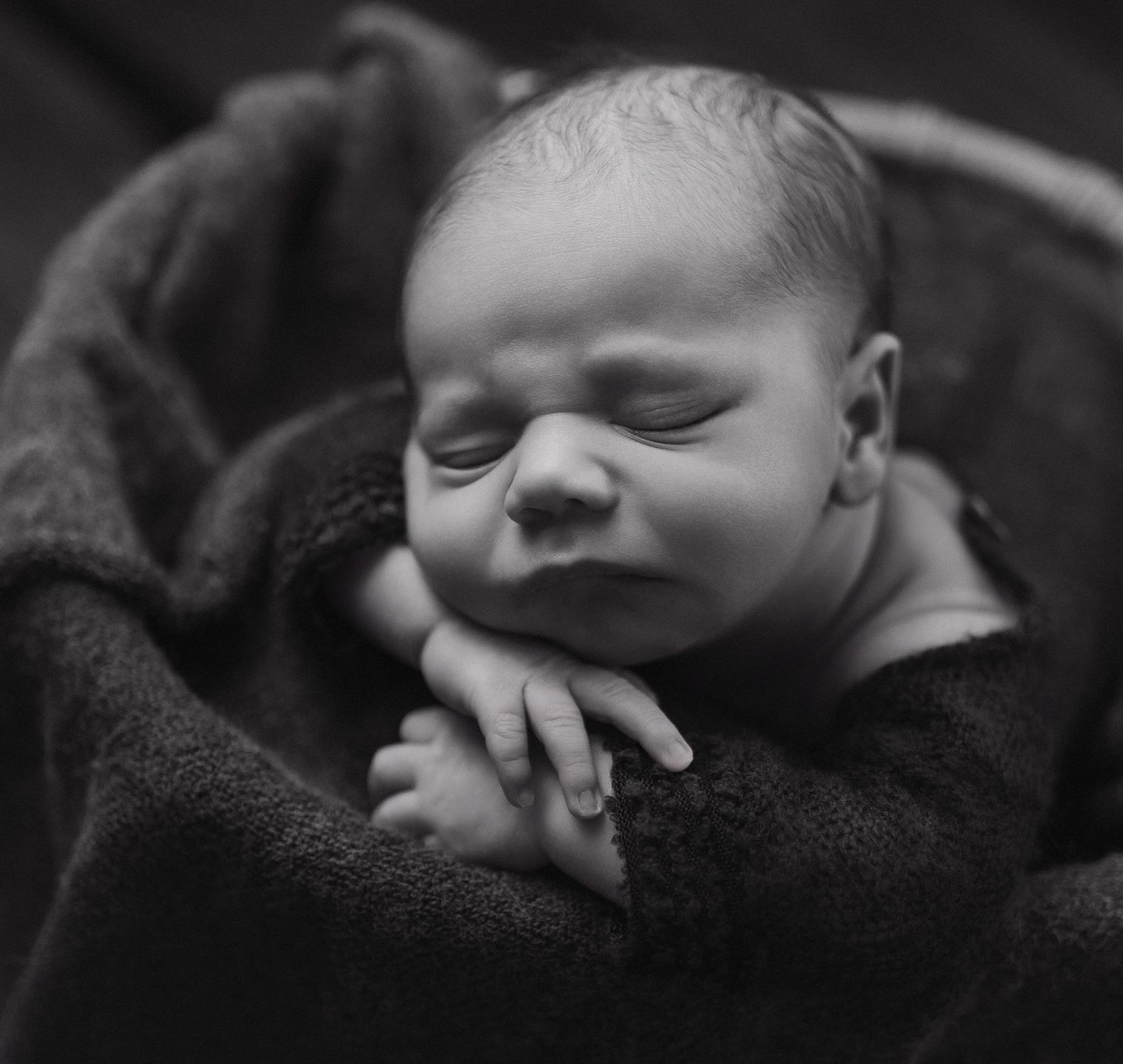 A black and white artistic photo series showing a baby lying down from different angles.