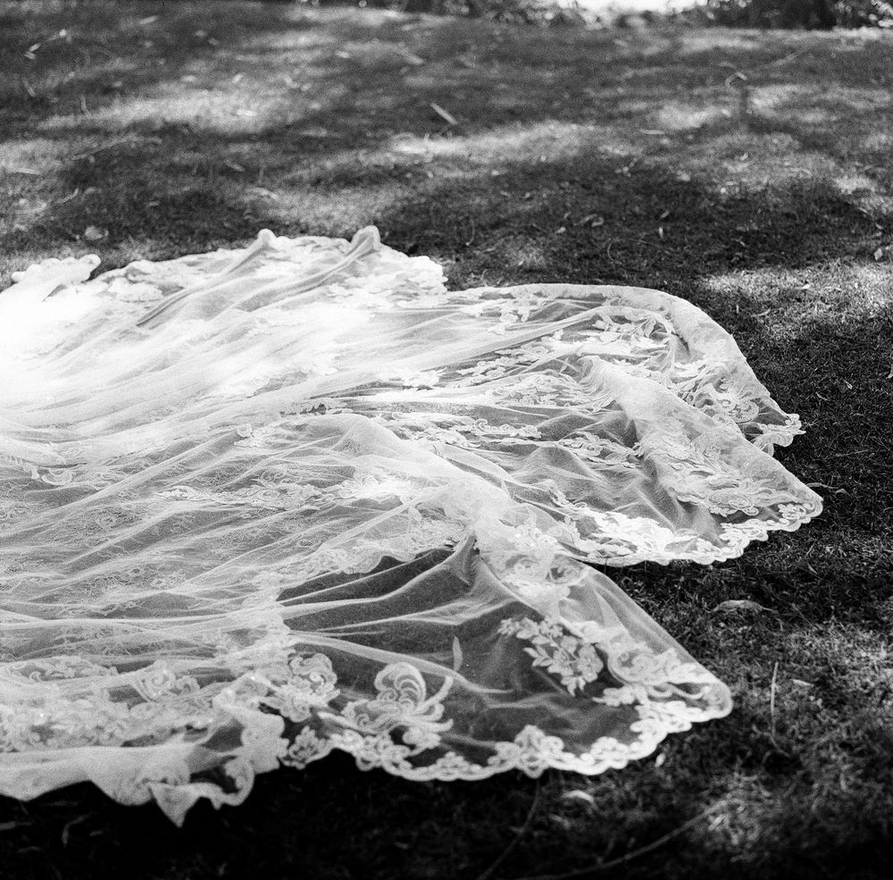 Black and white series showing flowing white fabric or veil against a dark textured background.