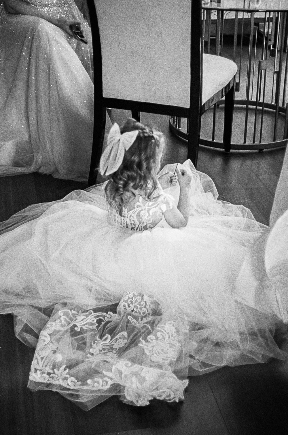 A series of black and white photographs showing the flowing layers and delicate details of a wedding dress train.