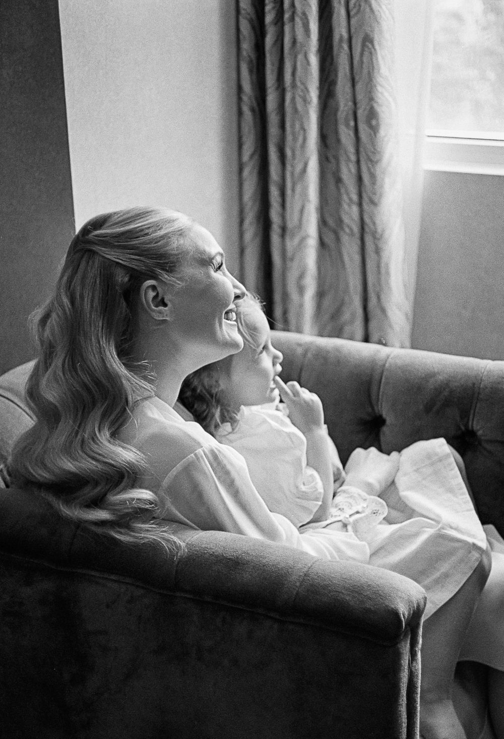 Black and white sequence of a woman reclining in a chair by a window with dramatic lighting.