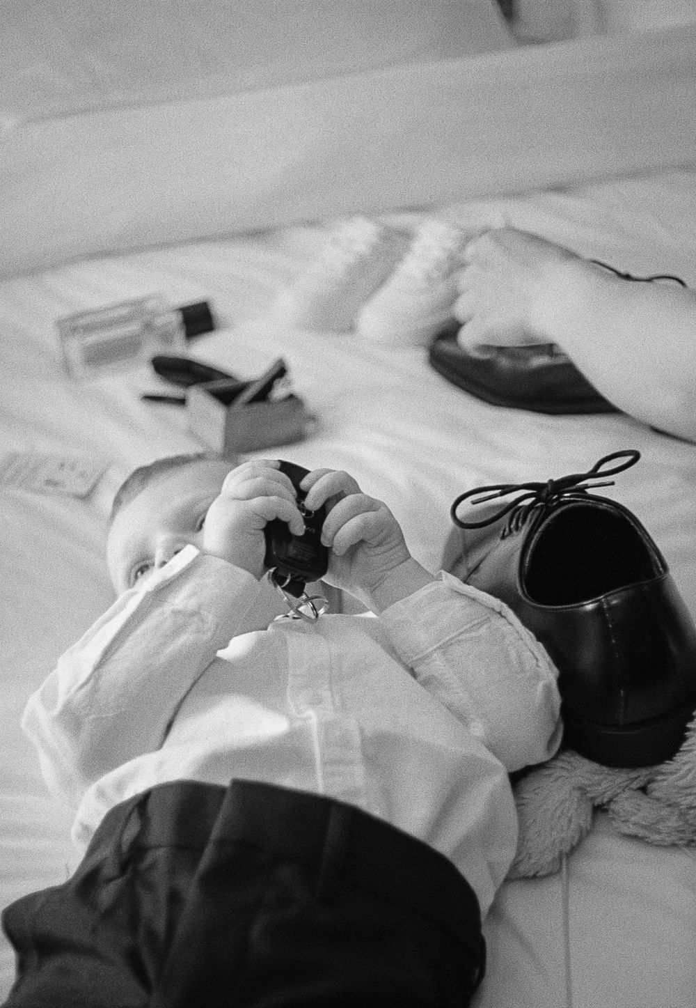 A sequence of monochrome images showing formal clothing laid out neatly on white fabric.