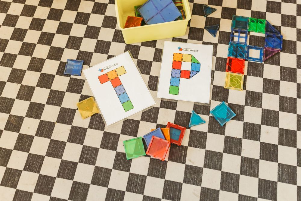 Black and white checkered floor with colorful building blocks scattered across the surface.