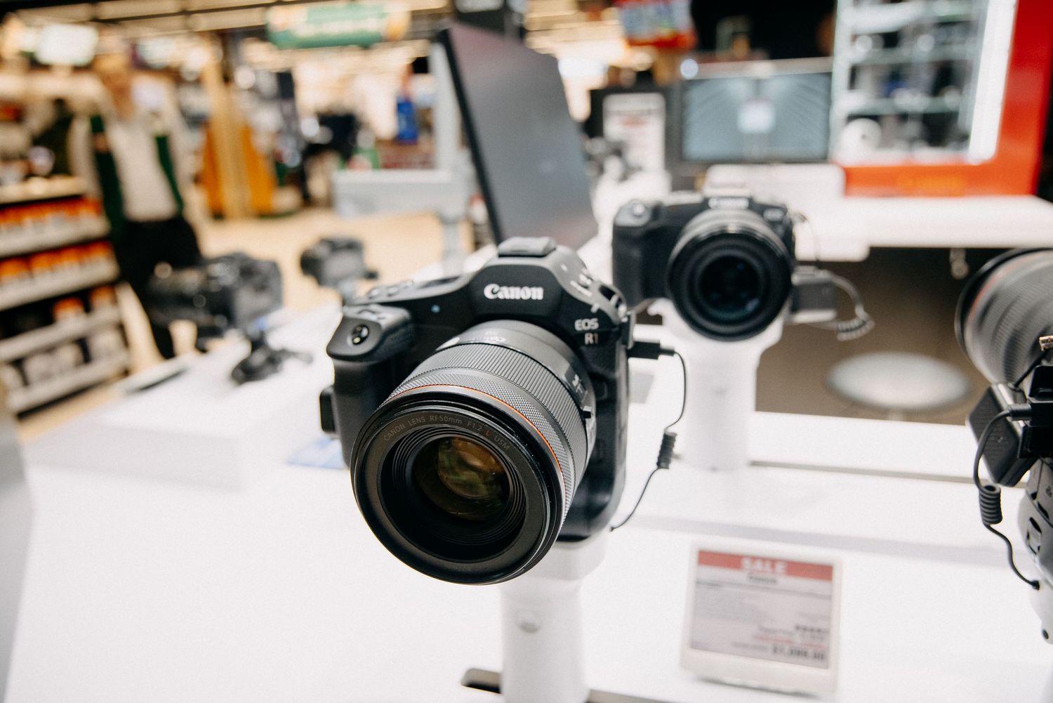 Display of various digital cameras and photography equipment in a retail setting.