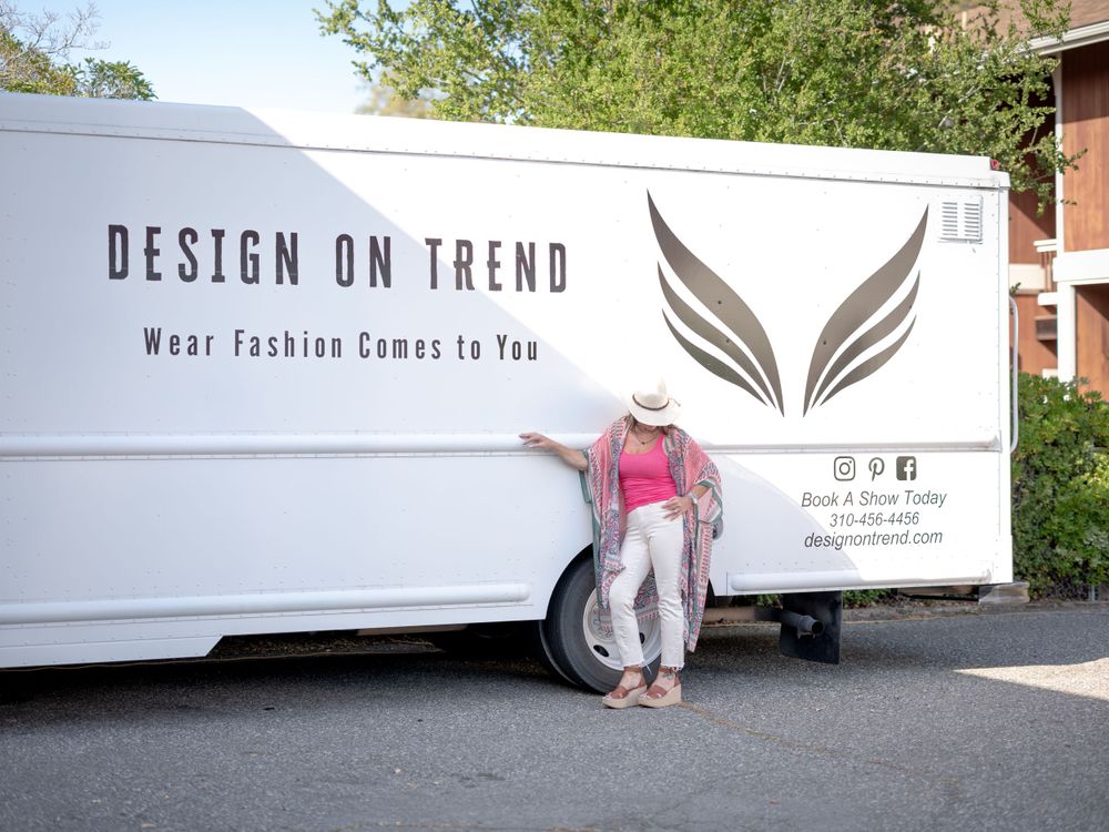 Mobile fashion boutique truck with wing logo and 'Design on Trend' branding parked outdoors.