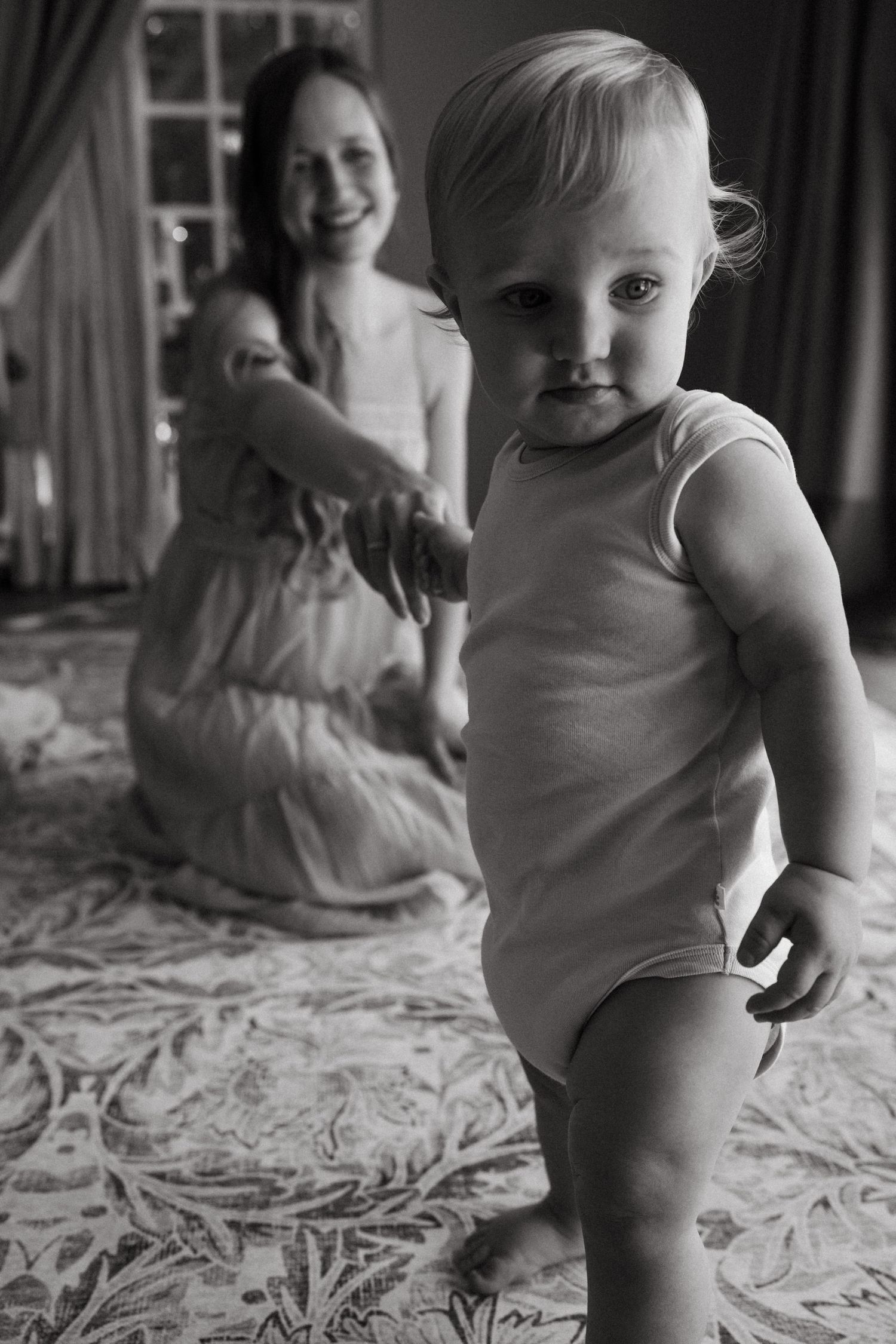 Black and white sequence showing playful interactions on a textured surface.