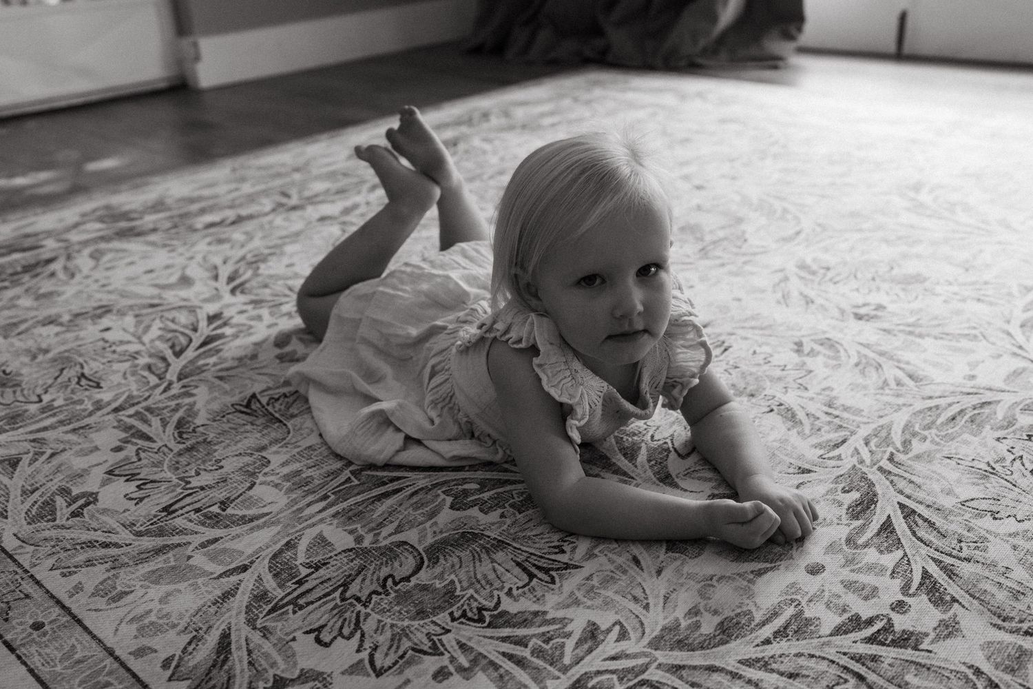Series of candid moments captured on a decorative bedspread in natural lighting.