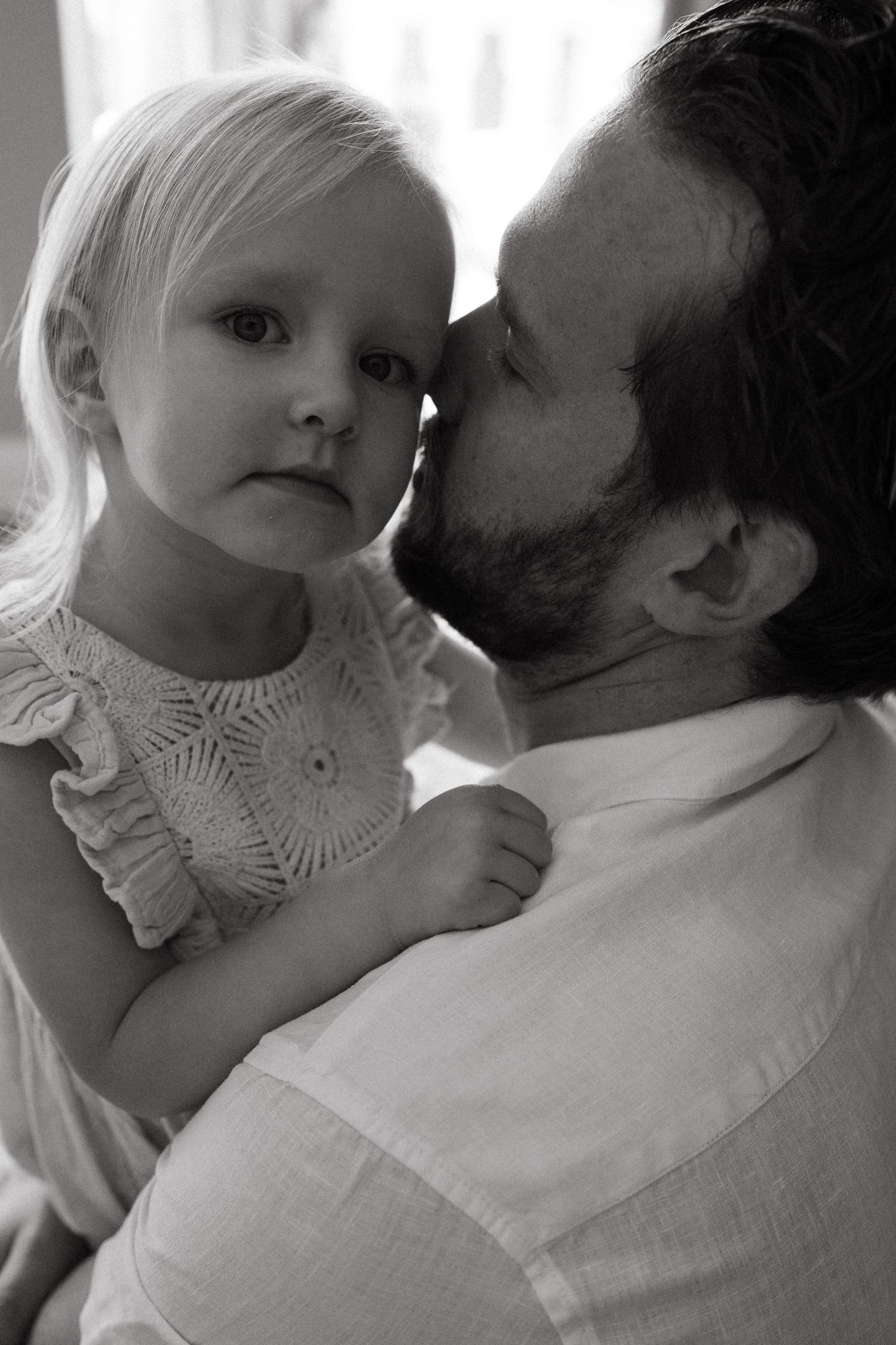 A tender black and white sequence showing intimate parent-child bonding moments.