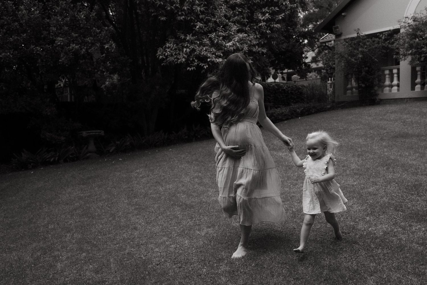 Silhouettes dance and play in a backyard during golden hour.