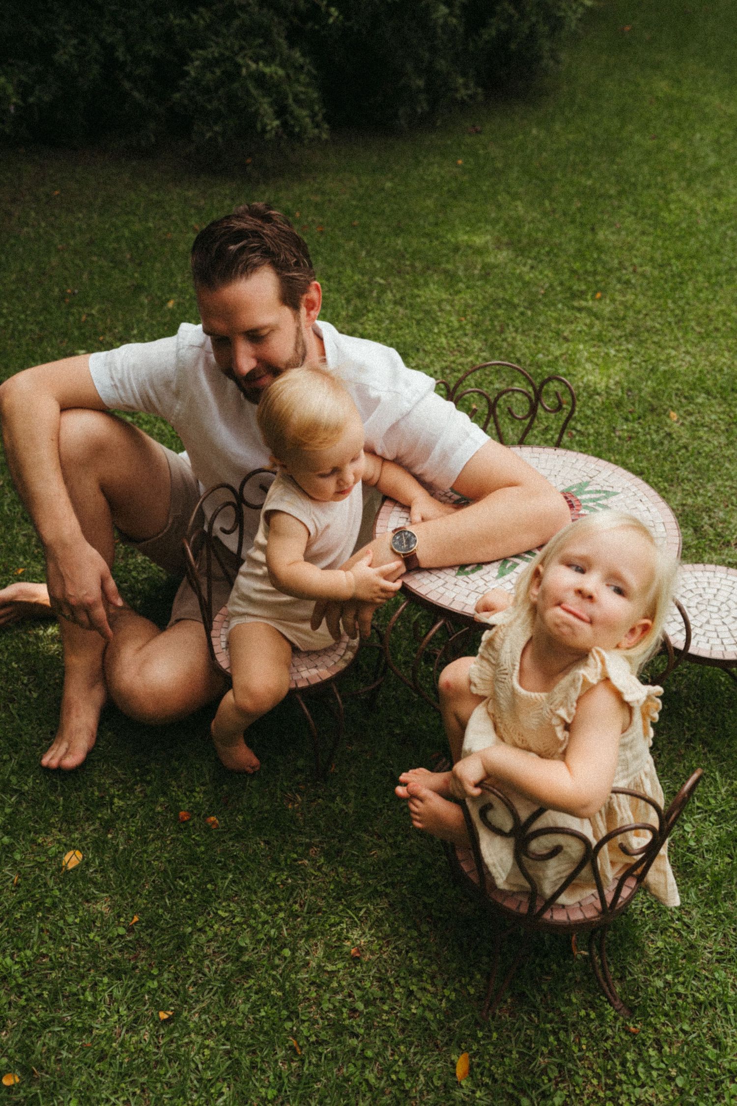 A joyful outdoor reading moment shared on a sunny lawn.