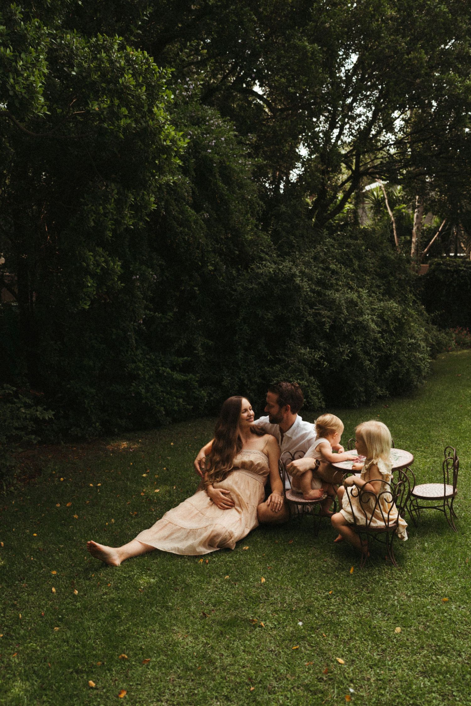 A playful sequence on grass showing intimate family moments outdoors.