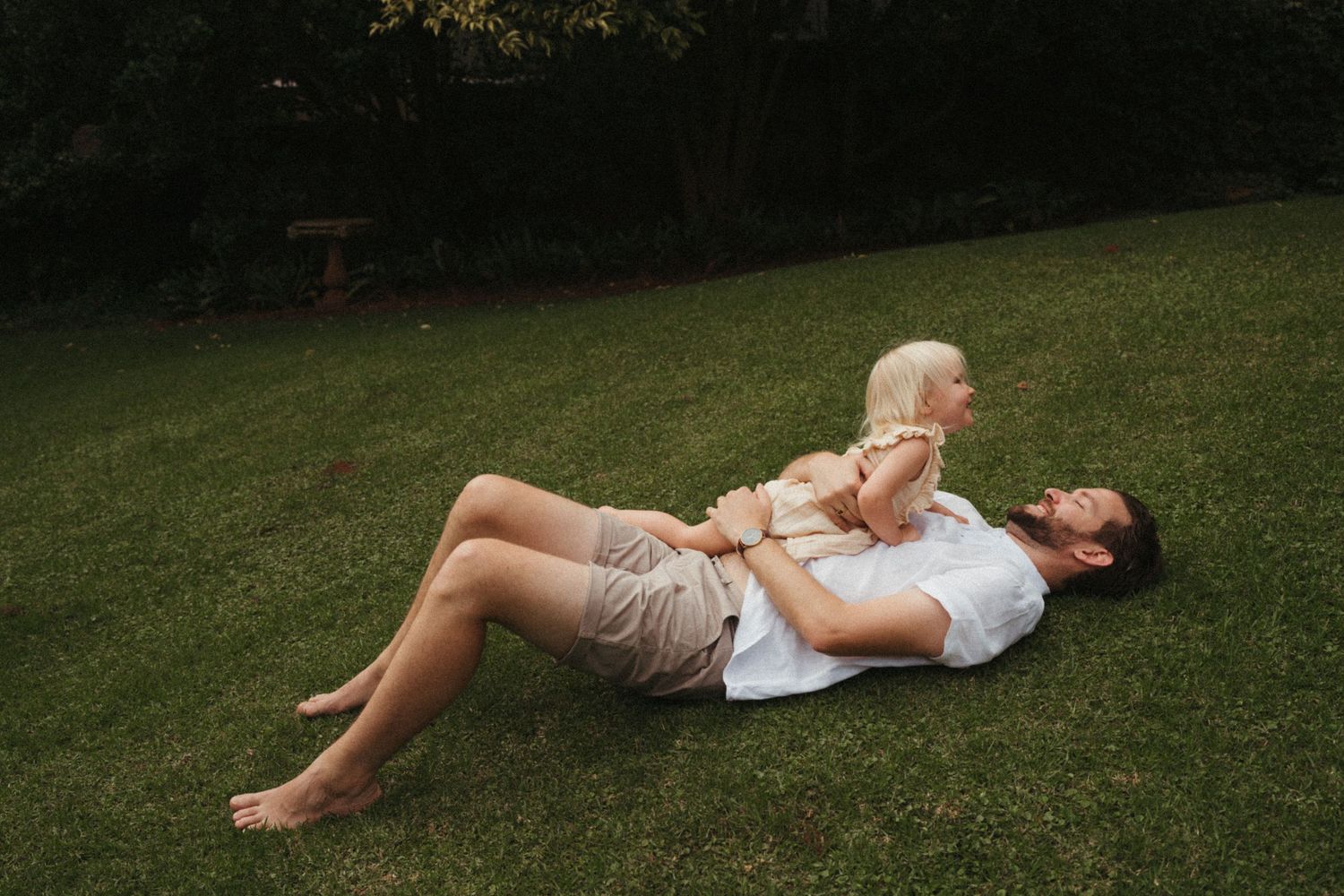 A sequence of relaxed poses on grass during a summer day.