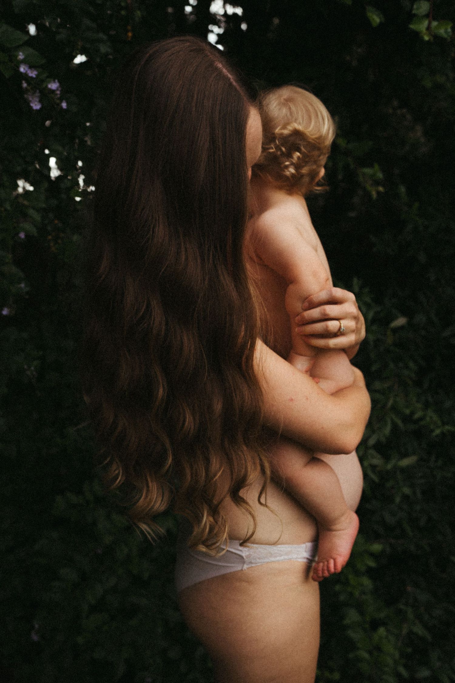 Intimate moments captured in warm sunlight against dark foliage.