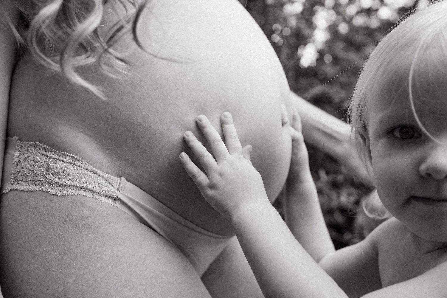 Black and white collage of candid baby photos showing sweet expressions and tender moments.
