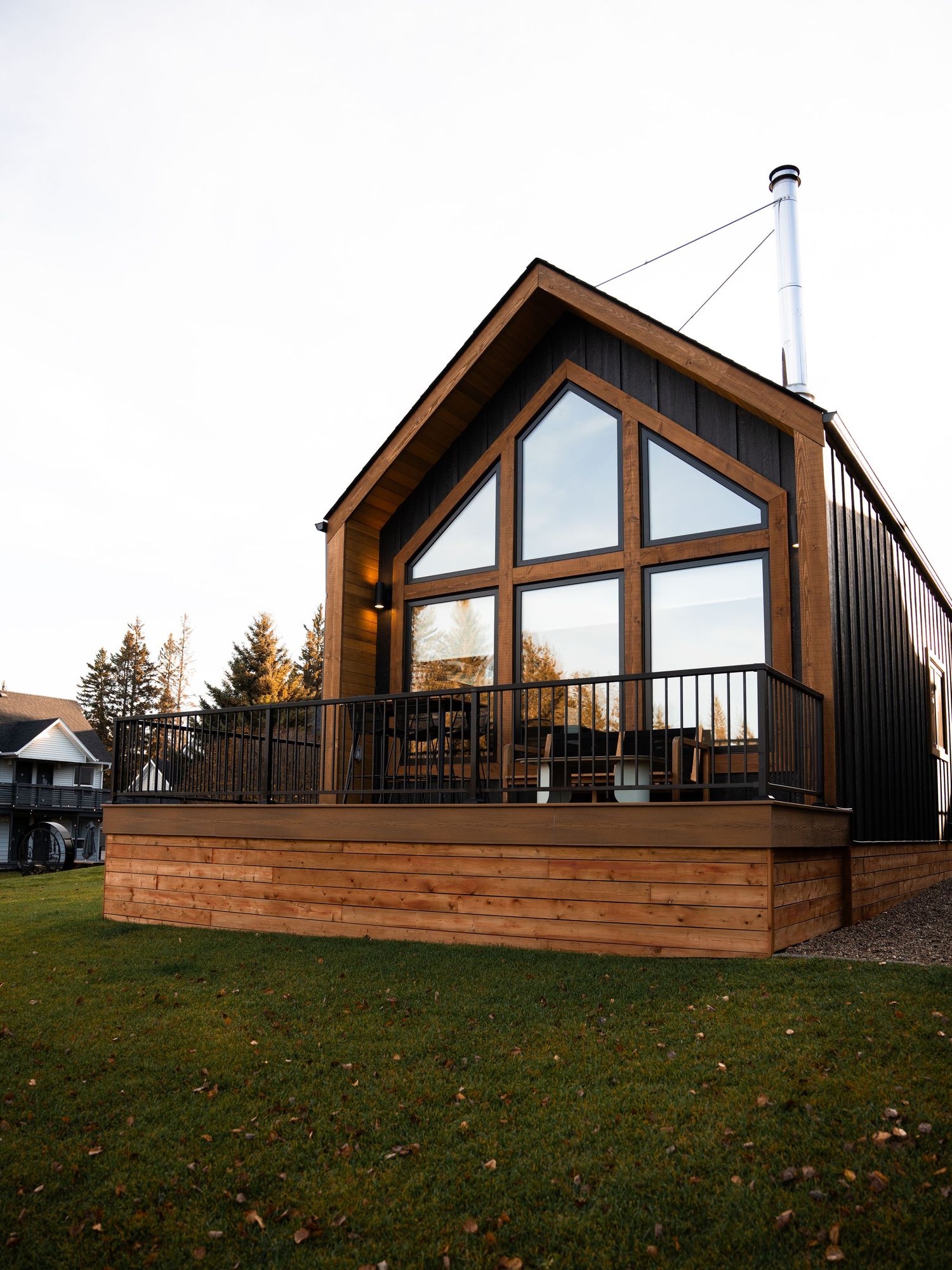 Modern wooden cabin rentals with large windows and deck railings.
