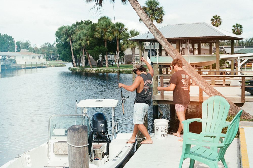 A collage of coastal lifestyle photos showing boats, docks, beach chairs, and waterfront scenes in warm sunlit settings.