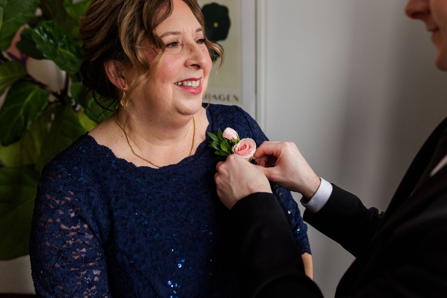 A series of candid photos showing someone in a navy blue lace dress laughing and smiling during a conversation.