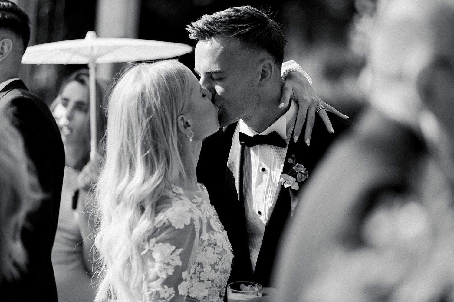 A couple shares a romantic moment during their wedding ceremony in black and white photography.