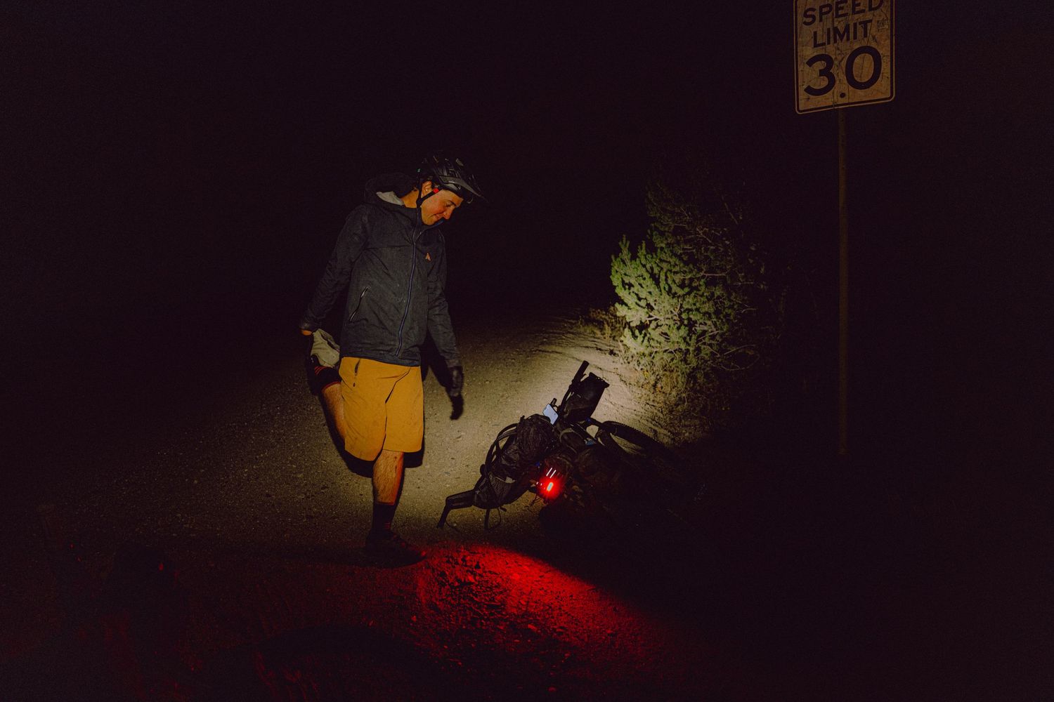 A sequence of dark silhouettes against a dimly lit background shows someone walking with a red light effect.